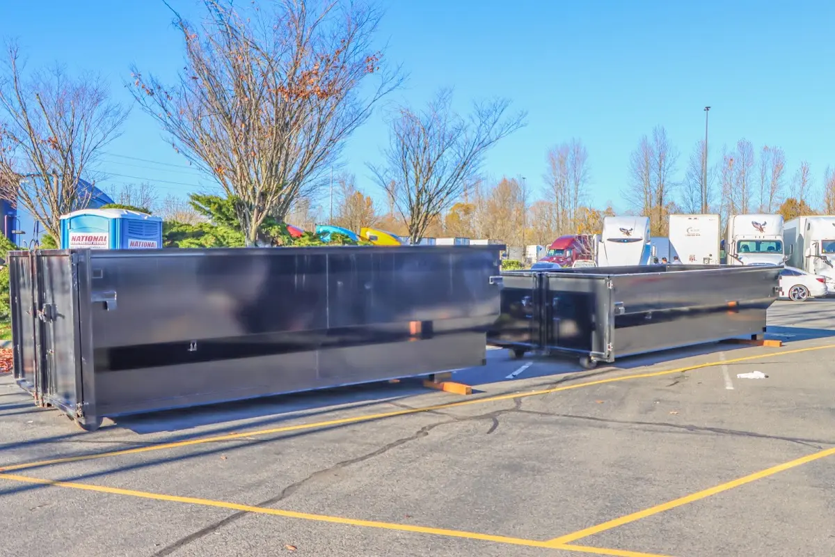 Professional dumpster rental service with roll-off container on residential driveway in La Grange